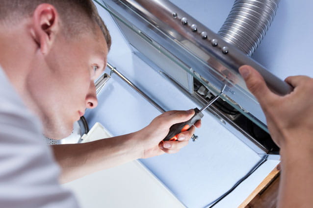 Técnico de reparación de campanas de HomeServe en una cocina
