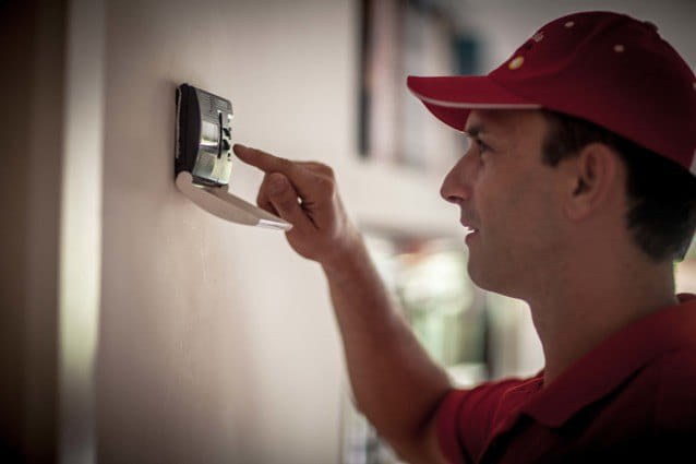 Técnico de HomeServe ajustando la temperatura del aire acondicionado